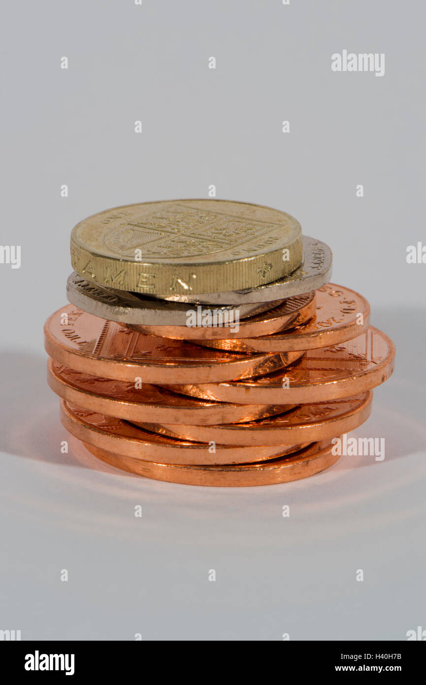 Stack of shiny, copper and silver coins ( 2p, 20p, £1) seen in close-up - this money (sterling) is current UK currency. Stock Photo