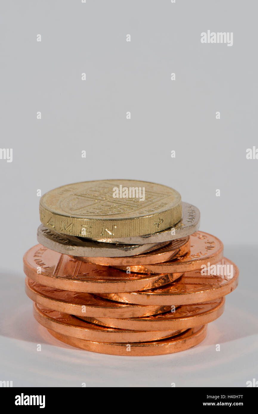 Stack of shiny, copper and silver coins ( 2p, 20p, £1) seen in close-up - this money (sterling) is current UK currency. Stock Photo