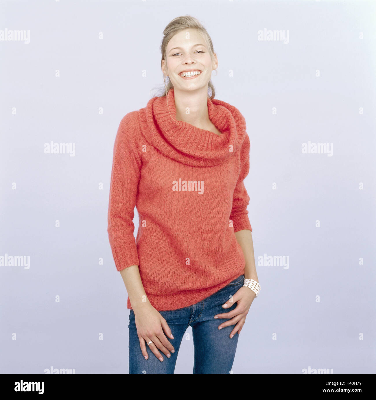 Youthfully, blond, view camera, smile, curled freely for Großflächenplakatierung 16-20 years, 20-30 years, woman, young, long-haired, hairs tied together, jeans, pullovers orange, knitted pullover, naturalness, do not stand, friendly, balance, happy, joy, Stock Photo