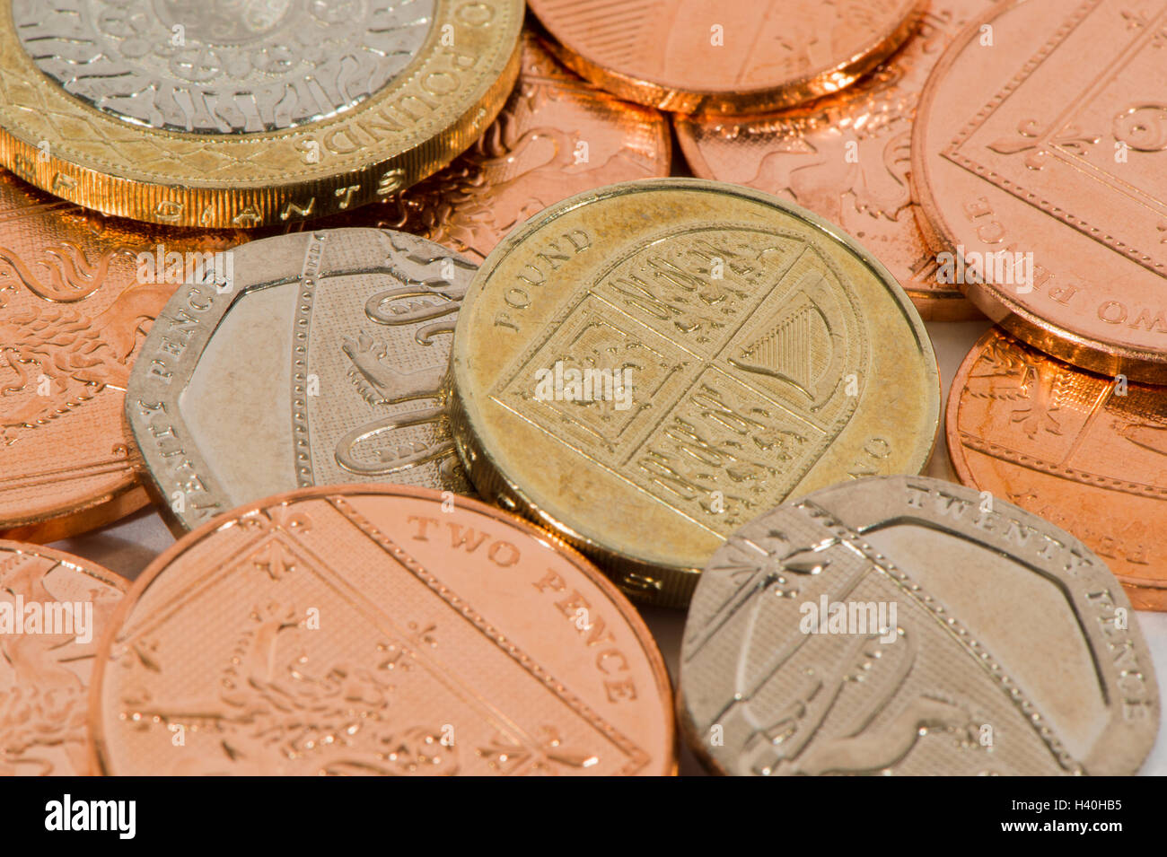 Close-up detail of money - current UK sterling coins in various denominations, both copper and silver - £2, £1, 20p, 2p. Stock Photo