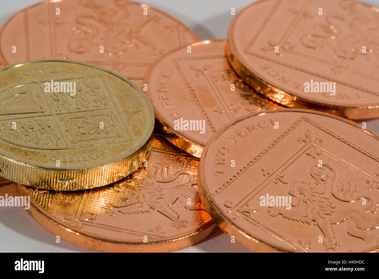 Close-up detail of money - current UK sterling coins in 2 denominations, copper and silver, with a single £1 amongst 2p pieces. Stock Photo