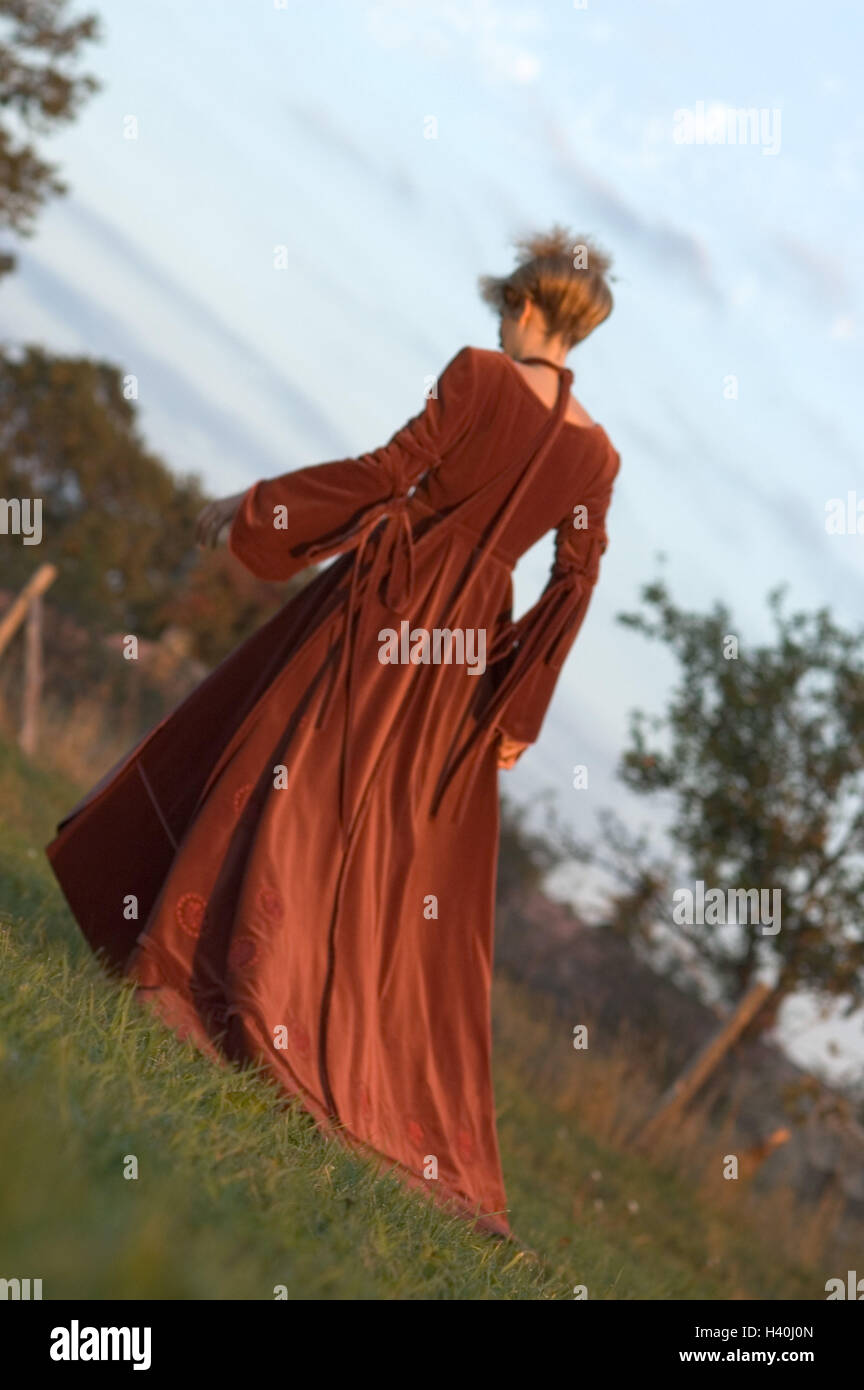 Park, woman, high hairdo, velvet dress, red, back view, evening sun meadow, 20-30 years, young, blond, velvet casing, go, motion, walk, clothes, elegantly, elegance, Russian fashion, romanticism, silence, loneliness, leisure time, recreation, rest, lifest Stock Photo