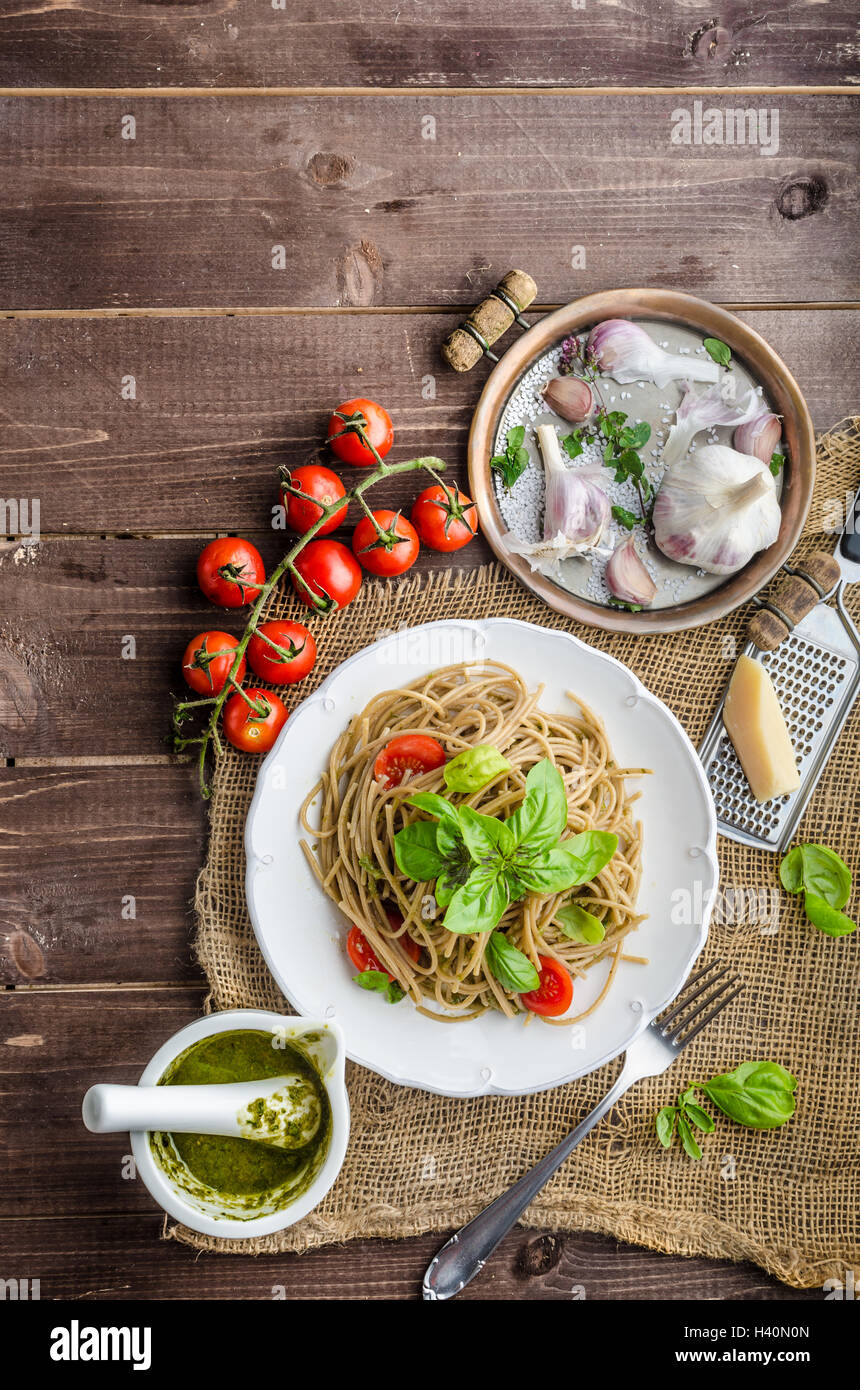Pasta with Milan pesto - basil with nuts and permesan, garlic and olive oil, delicious and genial food. Stock Photo