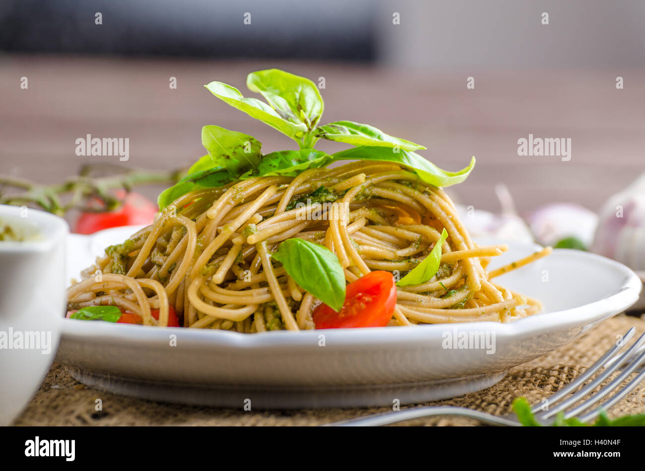 Pasta with Milan pesto - basil with nuts and permesan, garlic and olive oil, delicious and genial food. Stock Photo