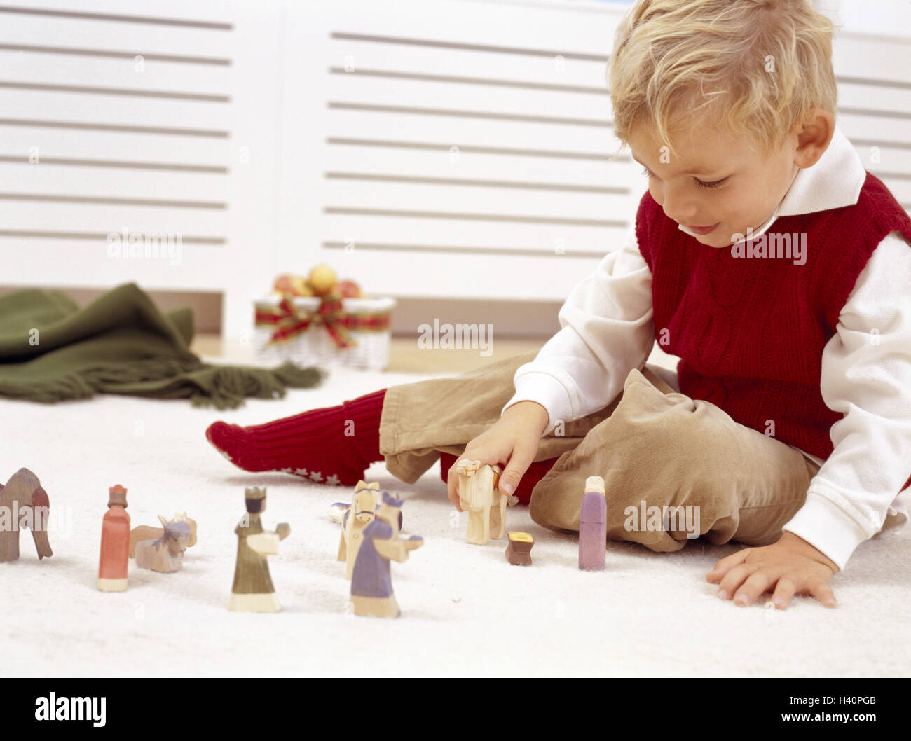 Christmas, floor, boy, nativity figurines, plays, yule tide, Advent season, Advent, child, infant, childhood, lighthearted, natural, characters, Wooden characters, game, activity, inside, for Christmas, prejoy Stock Photo