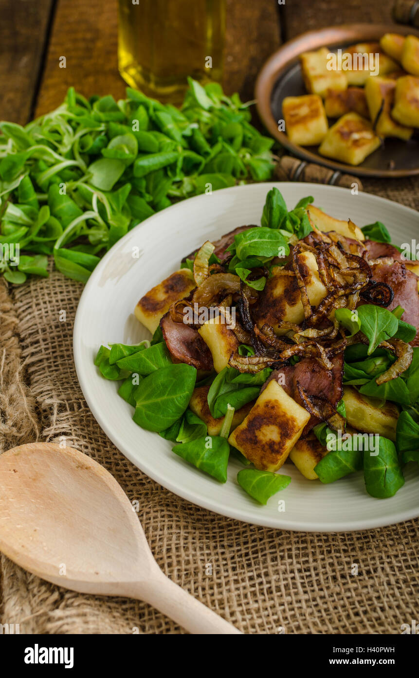 Potato gnocchi with summer salad, bacon and fried onions. Gnocchi