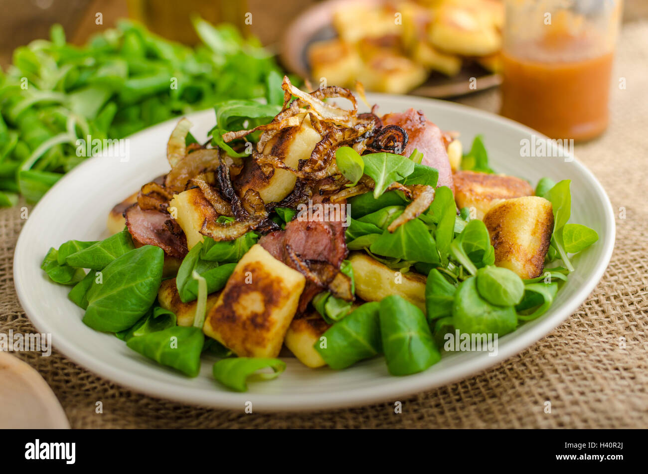 Potato gnocchi with summer salad, bacon and fried onions. Gnocchi