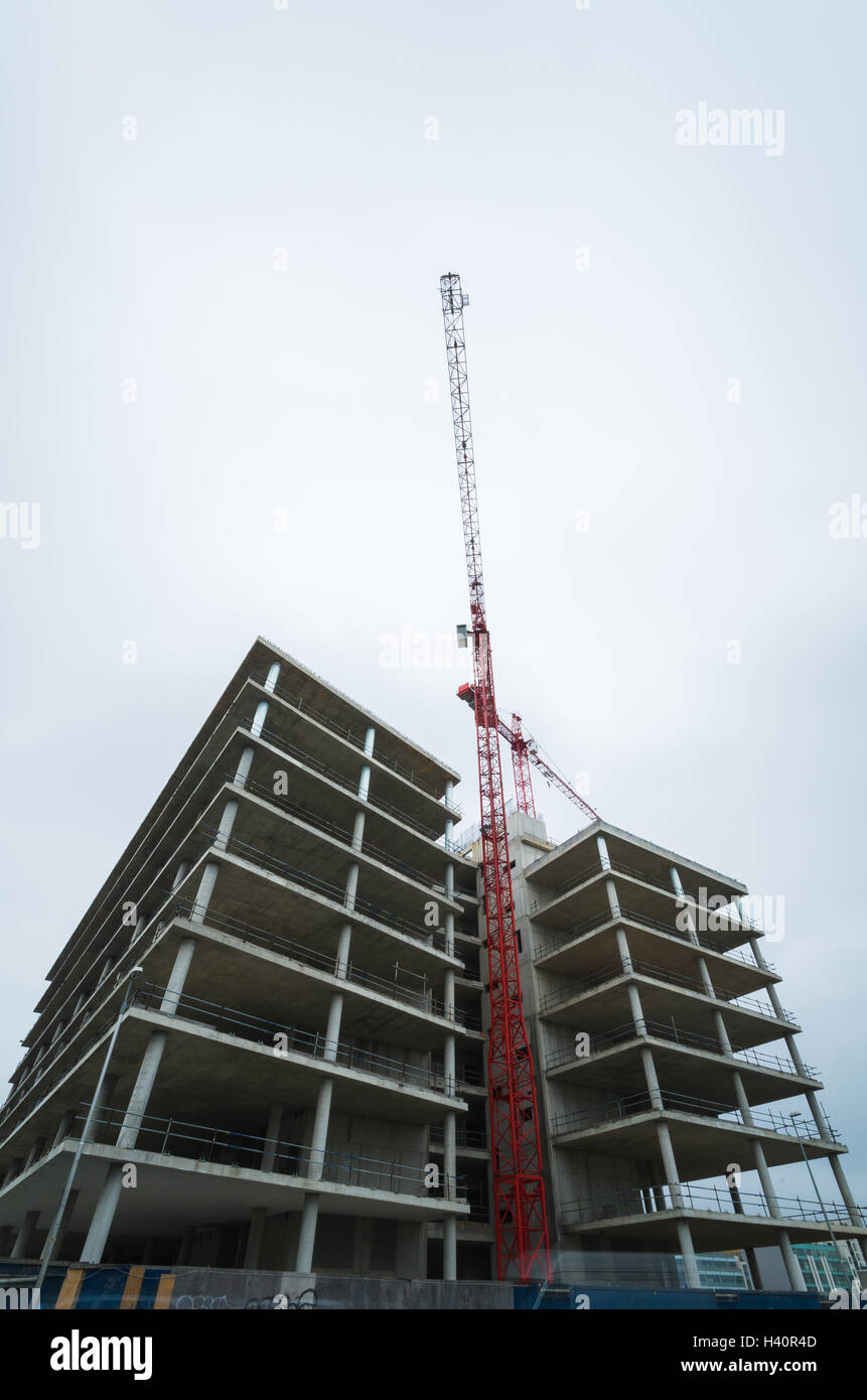 Construction site with crane on cloudy blue sky Stock Photo - Alamy