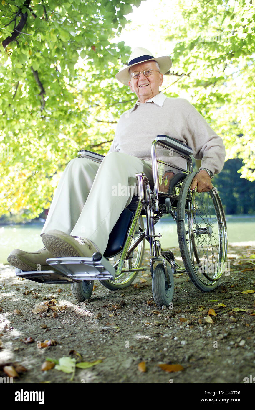 Park, boss, cheerfulness, invalid's wheel chair, sit, enjoy man, pensioner, invalid's wheel chair driver, glasses, wearers of glasses, care, headgear, fun, happily, joy of life, nature, riverside, way, obstacle, difficulty, handicap, ease, easily Stock Photo