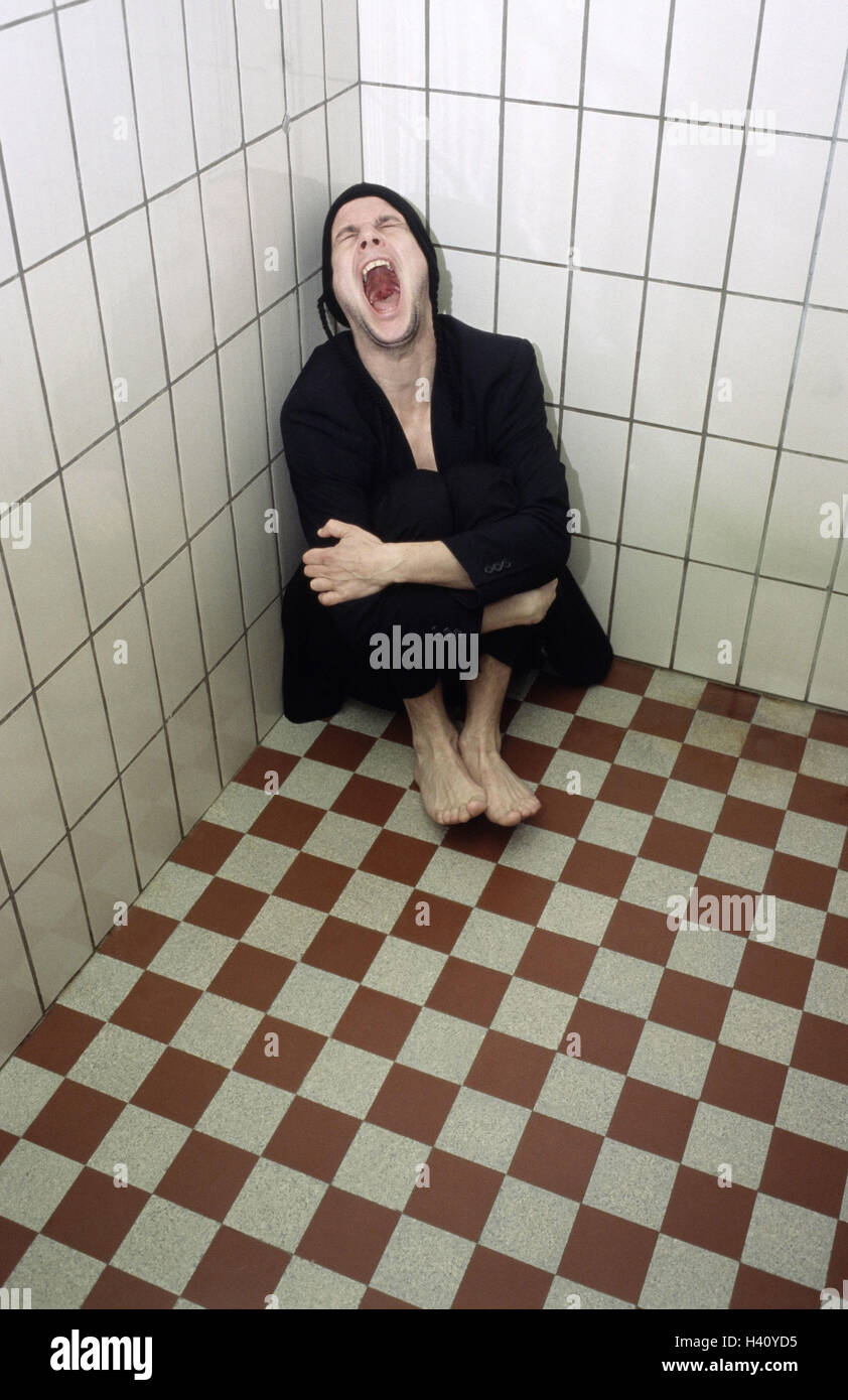 Chill house, tiled, man, suit, shout, desperation, helplessness, slaughter-house, 30-40 years, sit, squatted, feebly, exited, loneliness, discouragement, problem, depressions, confusion, oppression, fear, feelings, emotion, lunacy, enclosed, emotional out Stock Photo