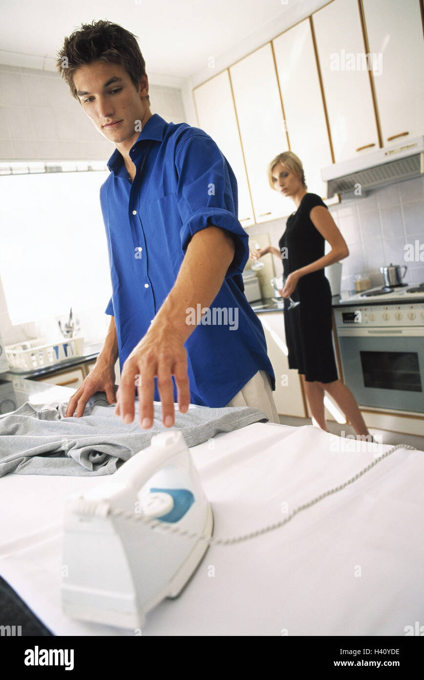 Cuisine, man, iron, woman, wineglasses partnership, respect, wine, glasses, carry, hold, husband, househusband, housework, ironing board, irons, division labour, rolling exchange, seriously, discontent, inside Stock Photo