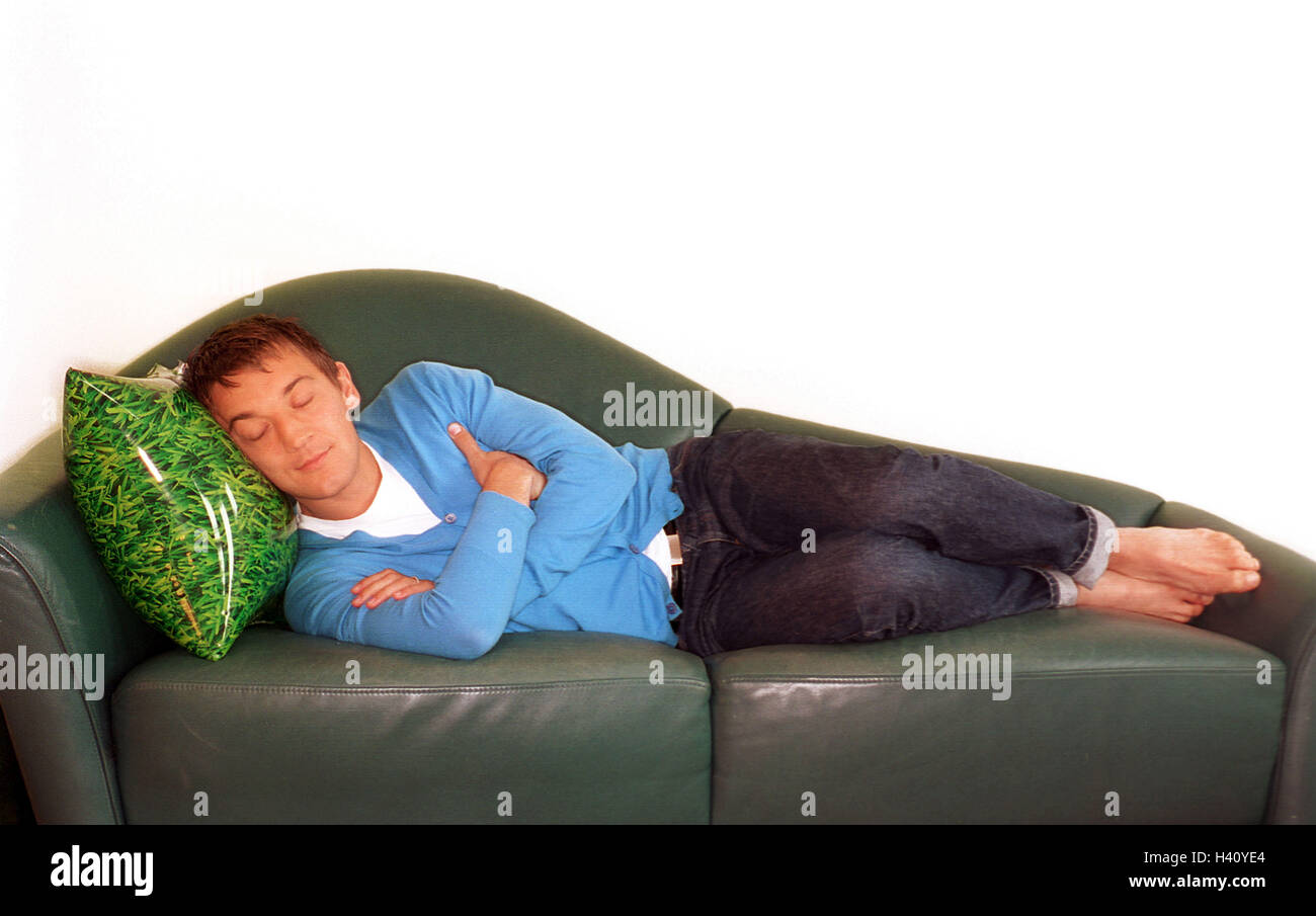 Man, sleep, sofa, cushion pneumatically, 20-30 years, tiredly, fatigue, rest, recreation, peacefully, smile, dream, sleep, rest, relax, barefoot, lie, side view, air cushions, grass samples, sleep, rest, take it easy, lazy, week-end, chaise longue Stock Photo