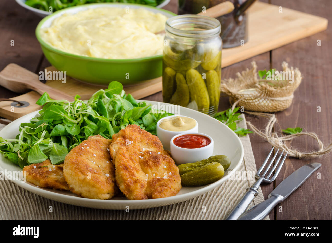 Schnitzel with mashed potatoes and salad, delicious pickles cucumber