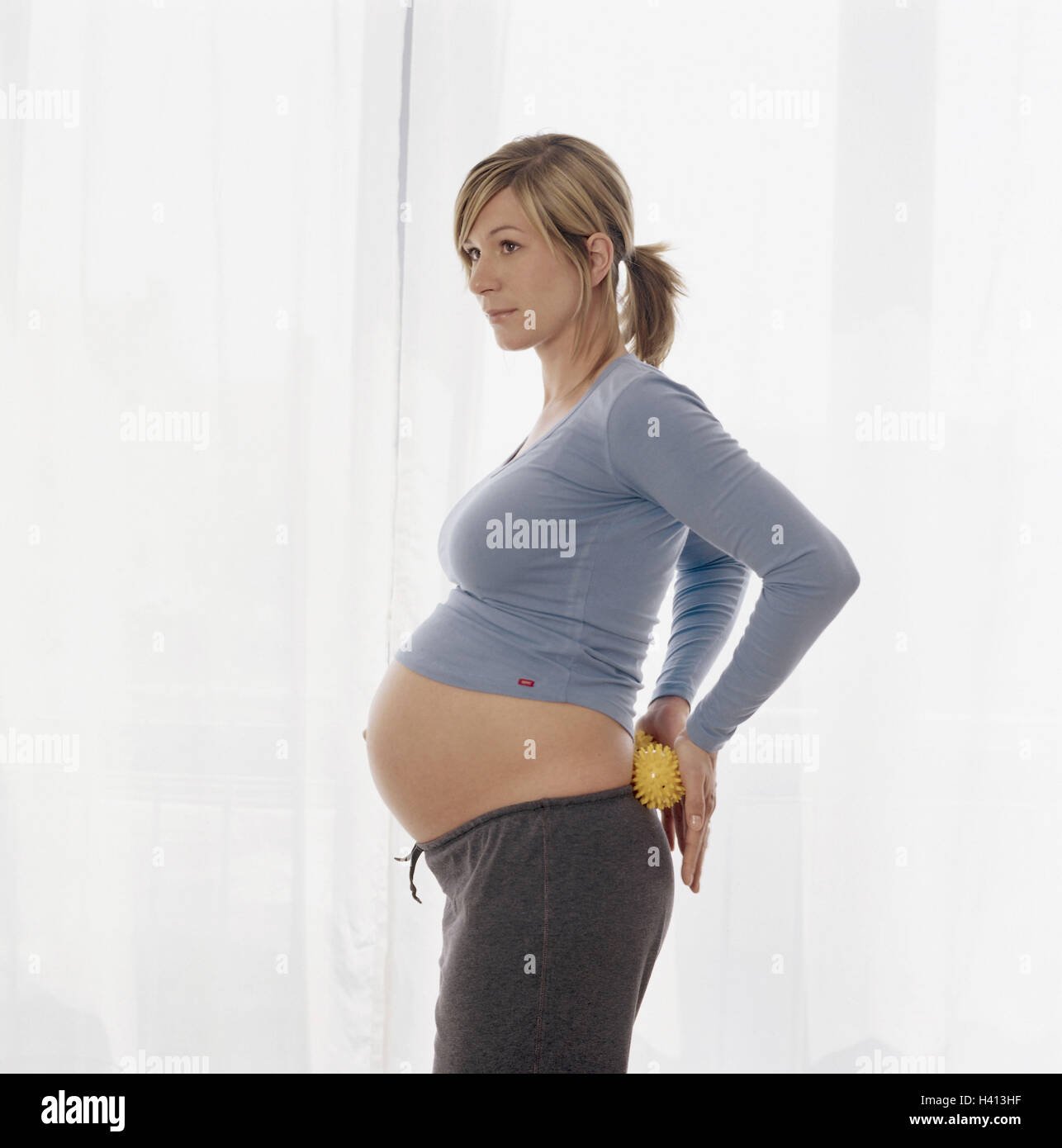 Woman, pregnant, stand, backs, hedgehog's balls, massage, side view, 20