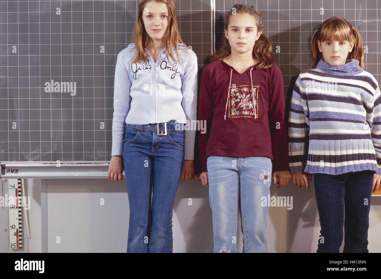 Classrooms, notice board, girl, stand school, class, class-mates, friends, 10 - 12 years, three, class community, common figureistic, cohesion, friendship, seriously Stock Photo