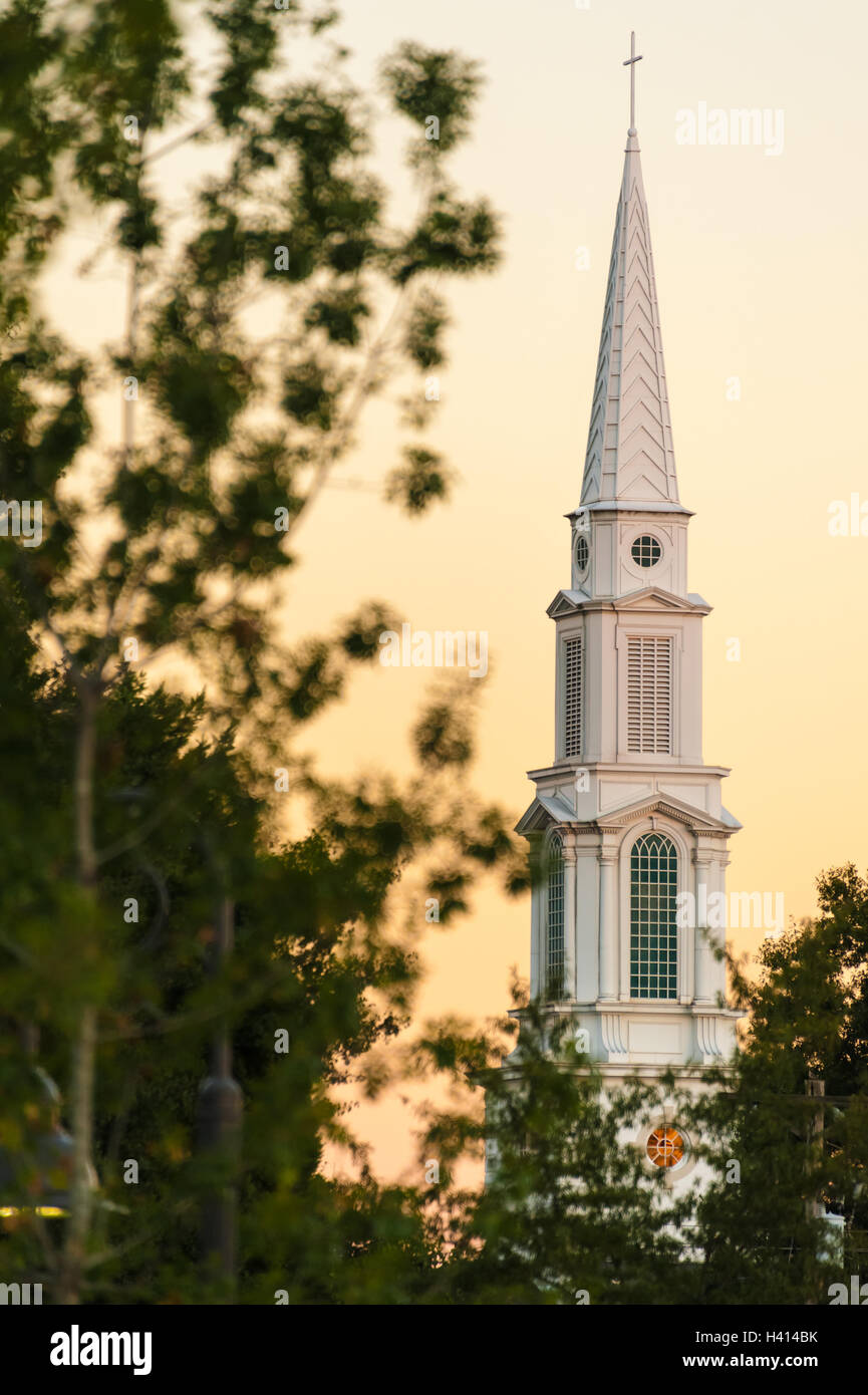 The white steeple of First Baptist Church Snellville stands tall in the warm glow of dusk in Snellville, Georgia, USA. Stock Photo