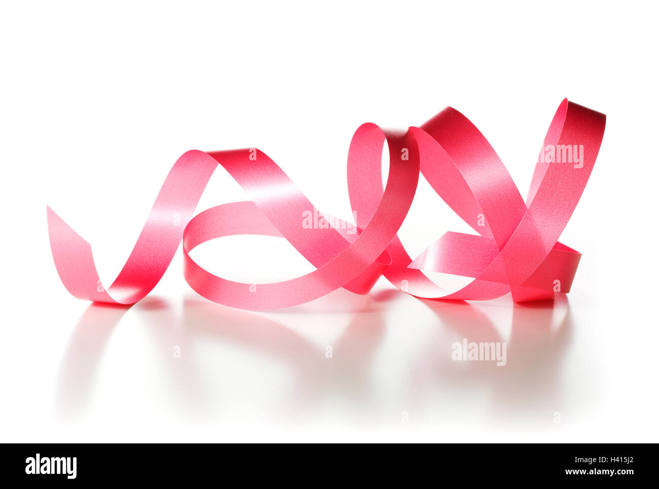 Red ribbon over white background, decorative element. Stock Photo