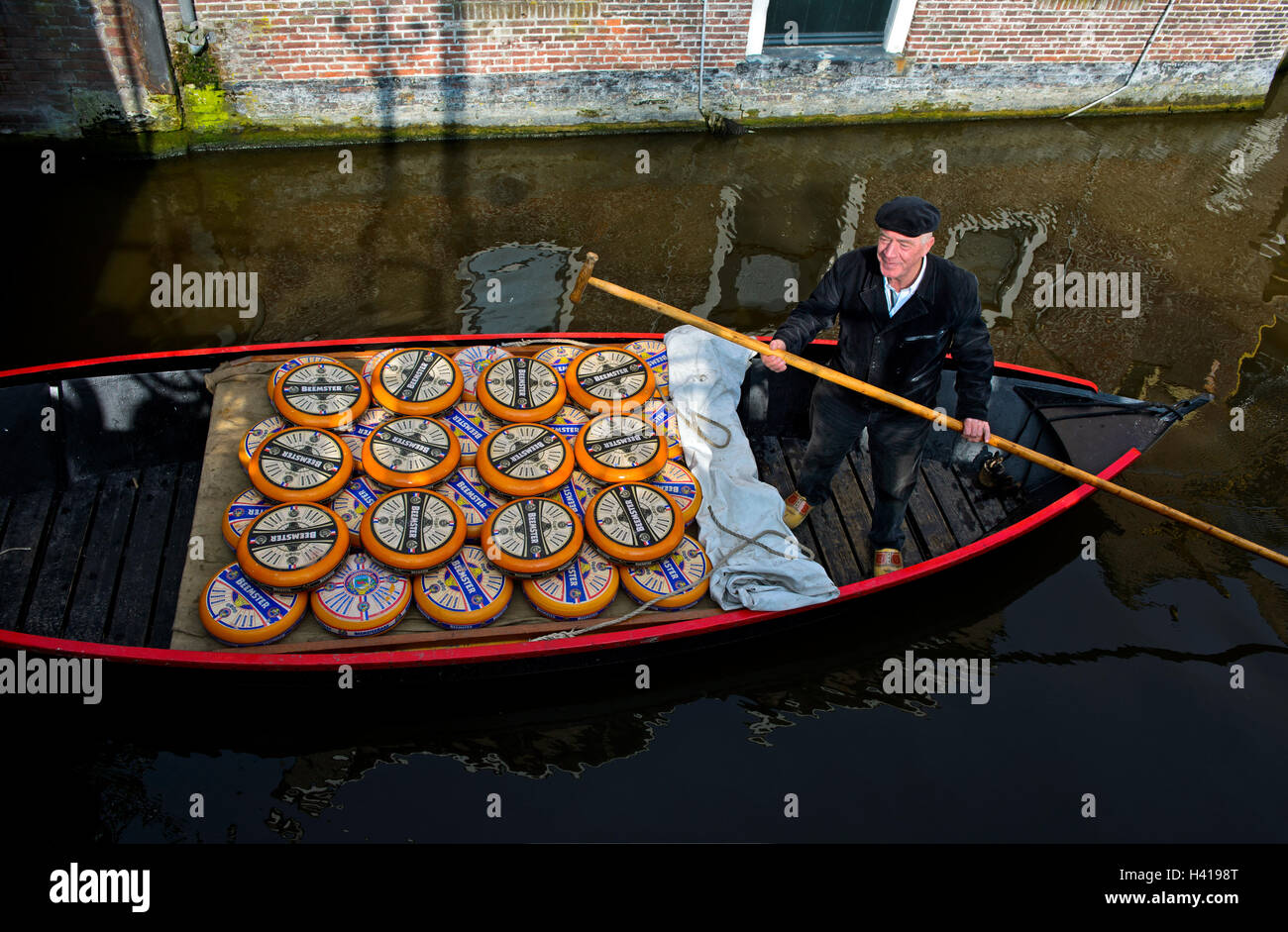 Transport of Beemster cheese in a boat with coxswain on a canal, Cheese market, Alkmaar, Netherland Stock Photo