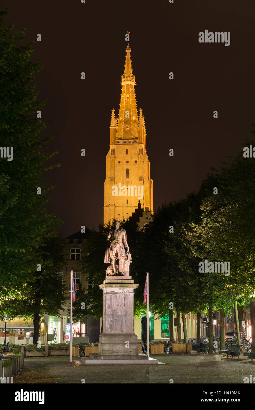 night picture of church and statue in Brugge, Belgium Stock Photo