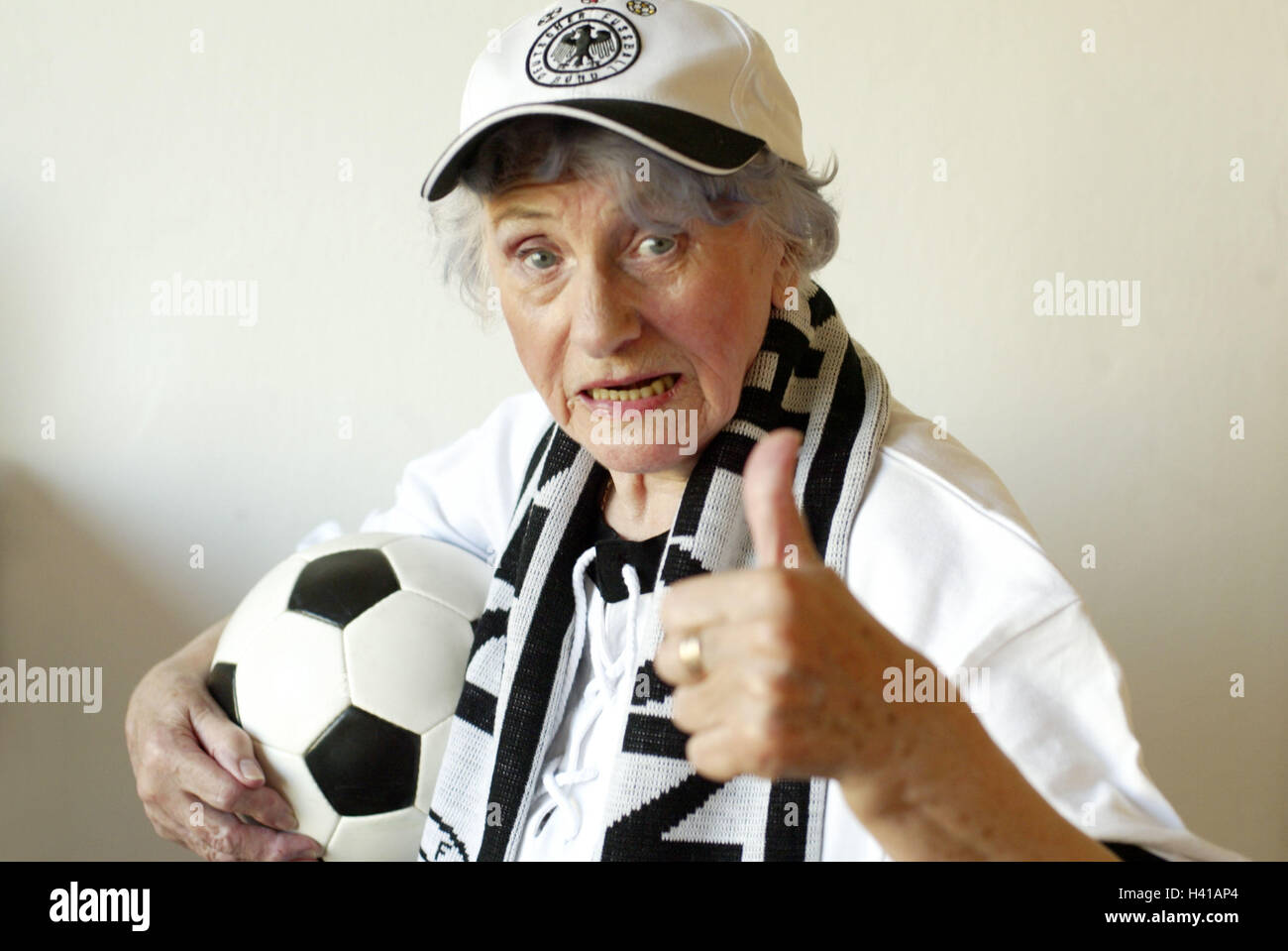 Senior, football fan, ball, gesture, pollex high, portrait, sport, football match, football match, spectator, senior, pensioner, woman, old, agile, actively, young remaining, fan, follower, football follower, hobby, keen on sport, excitedly, employs, is c Stock Photo