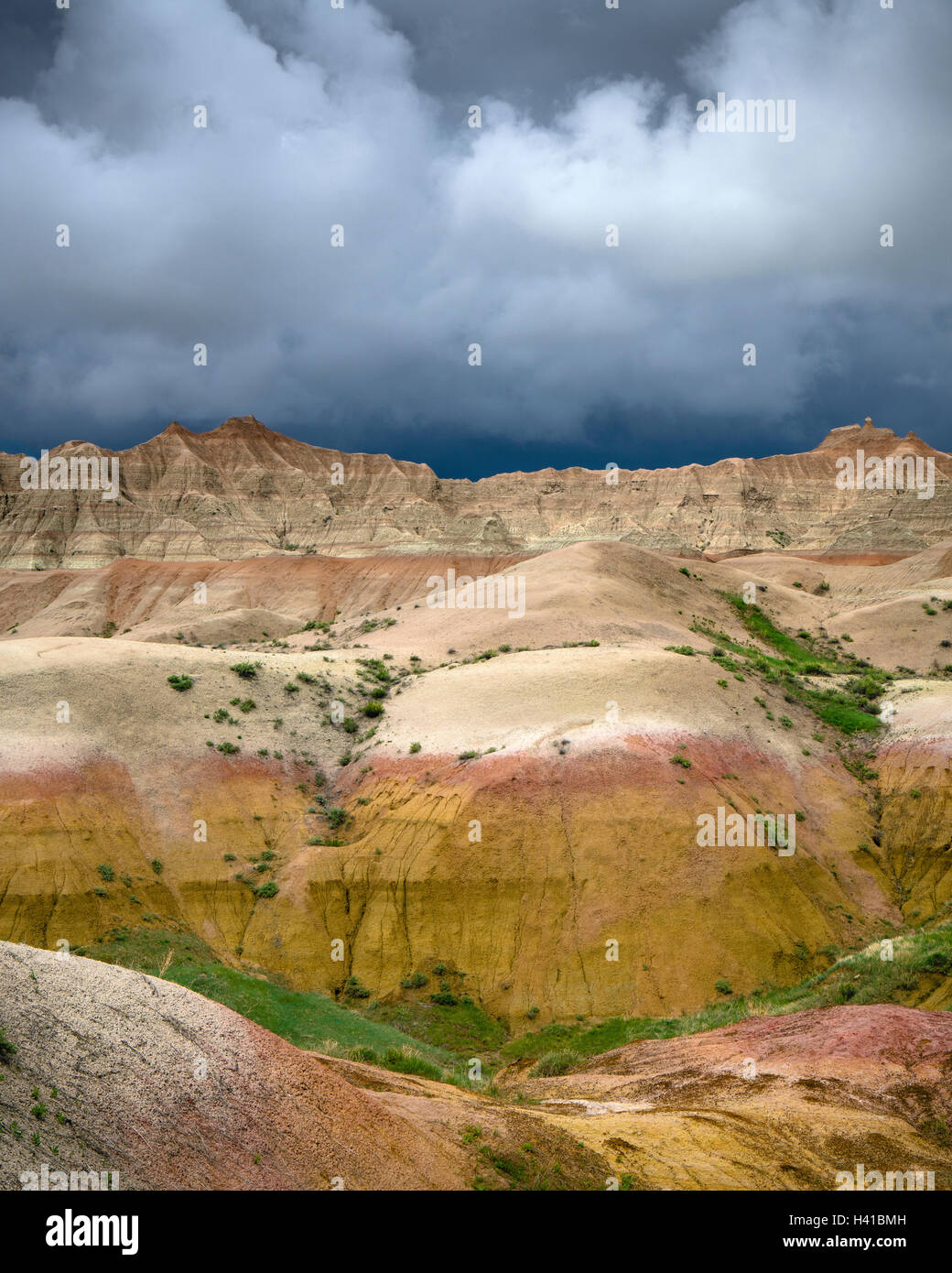 Badlands National Park, South Dakota:   Clearing storm clouds over the eroded Yellow Mounds landforms near Dillon pass Stock Photo