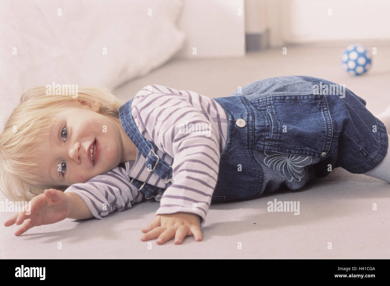 Infant, lie, floor inside, child, girls, blond, sitting room, happy, ball, play, game, boredom, boringly, only Stock Photo