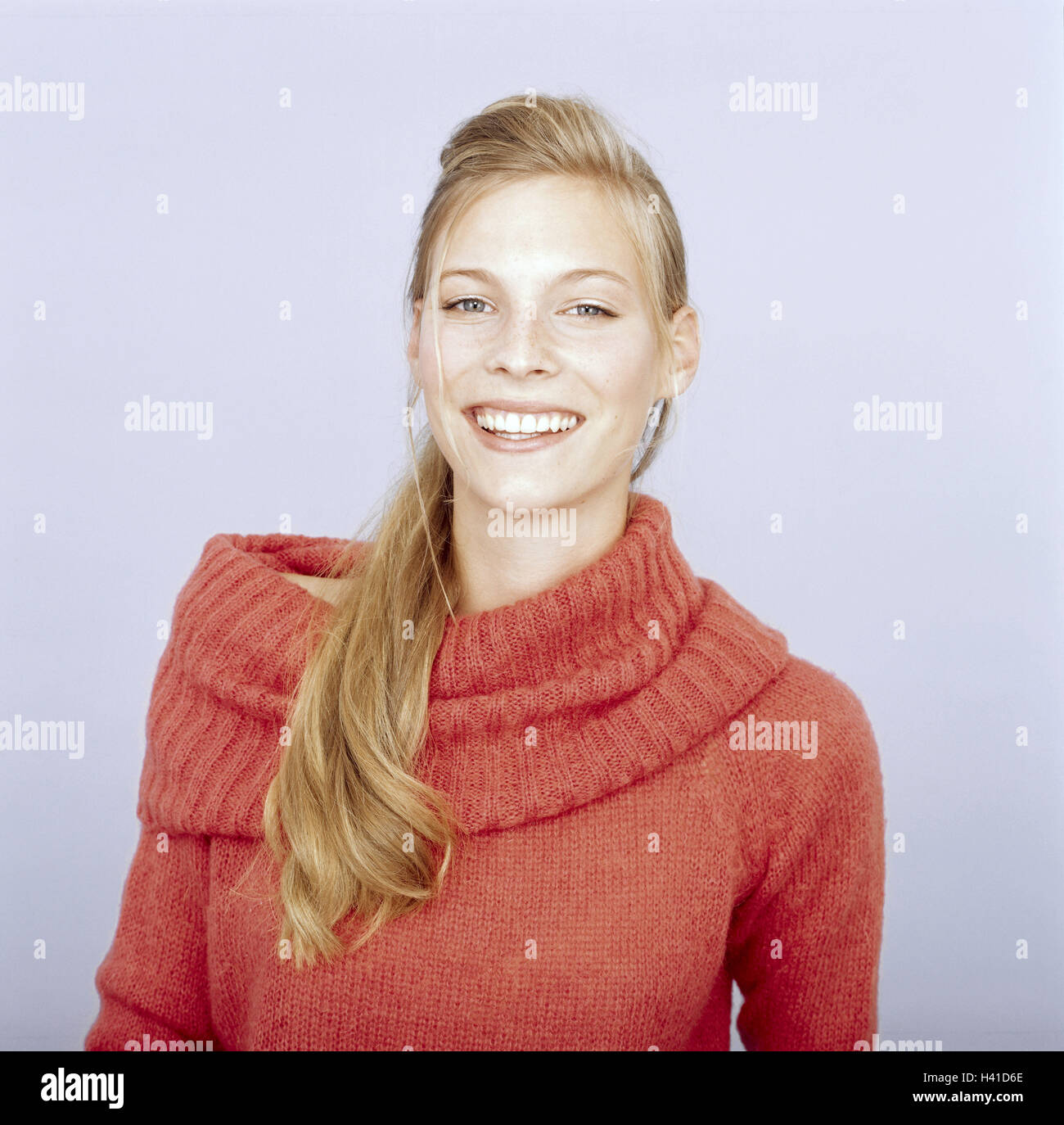 Youthfully, blond, view camera, smile, portrait, freely for Großflächenplakatierung 16-20 years, 20-30 years, woman, young, long-haired, hairs tied together, pullovers orange, knitted pullover, naturalness, do not stand, friendly, balance, happy, joy, hap Stock Photo