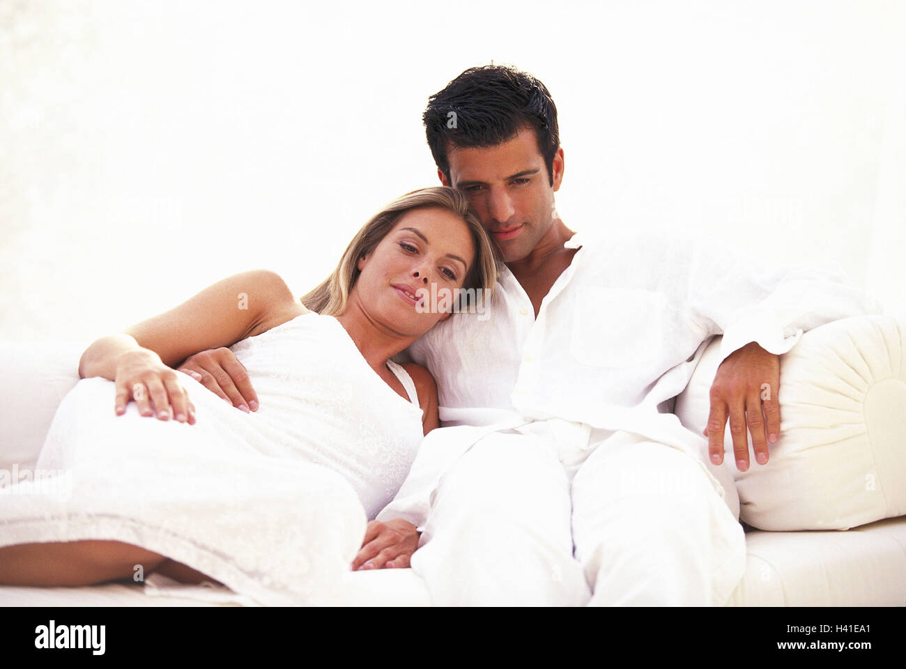 Sofa, pair, happily, falls in love, relaxen   28 years, 20-30 years, partnership, relationship, affection, love, tenderness, touch, nestles, recuperation, relaxation, togetherness, rests leisure time, weekend clothing knows Stock Photo