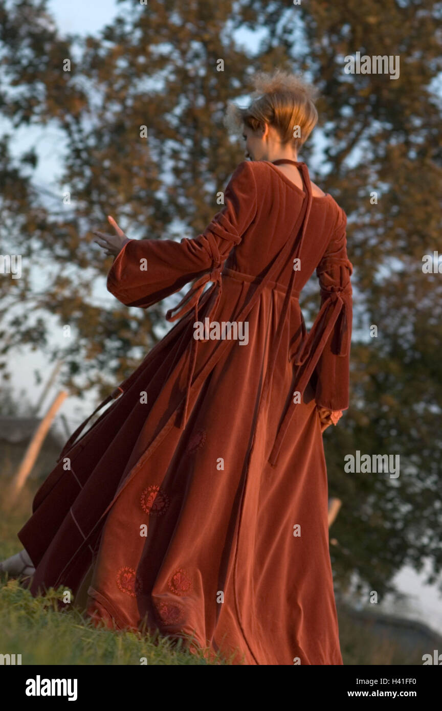 Park, woman, high hairdo, velvet dress, red, back view, evening sun meadow, 20-30 years, young, blond, velvet casing, go, motion, gesture, hand, fury, rage, annoyance, desperation, walk, clothes, elegantly, elegance, Russian fashion, romanticism, silence, Stock Photo
