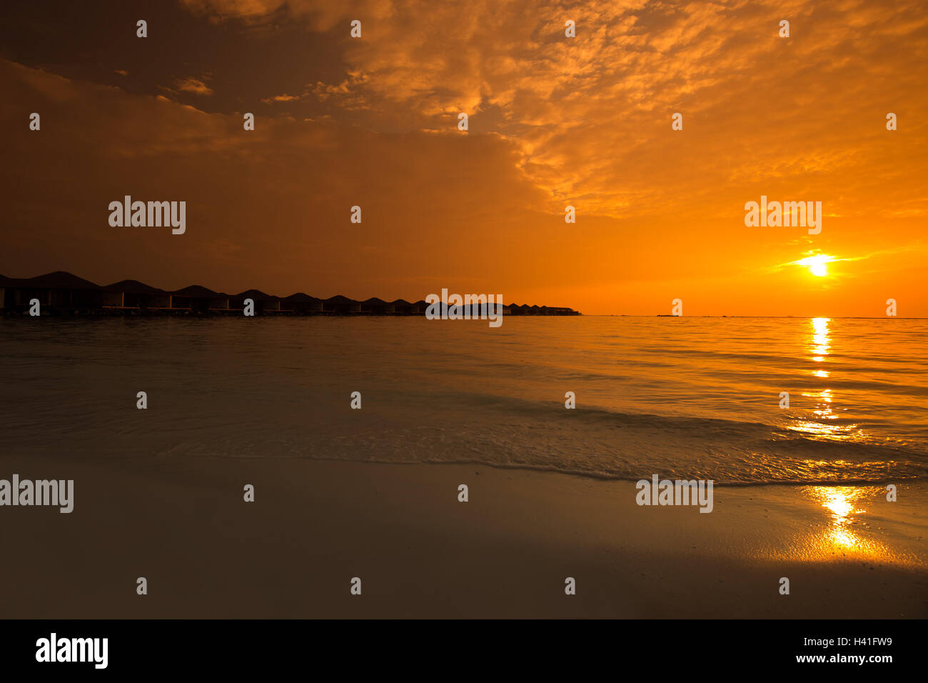 Beautiful sunset at tropical resort with overwater bungalows Stock