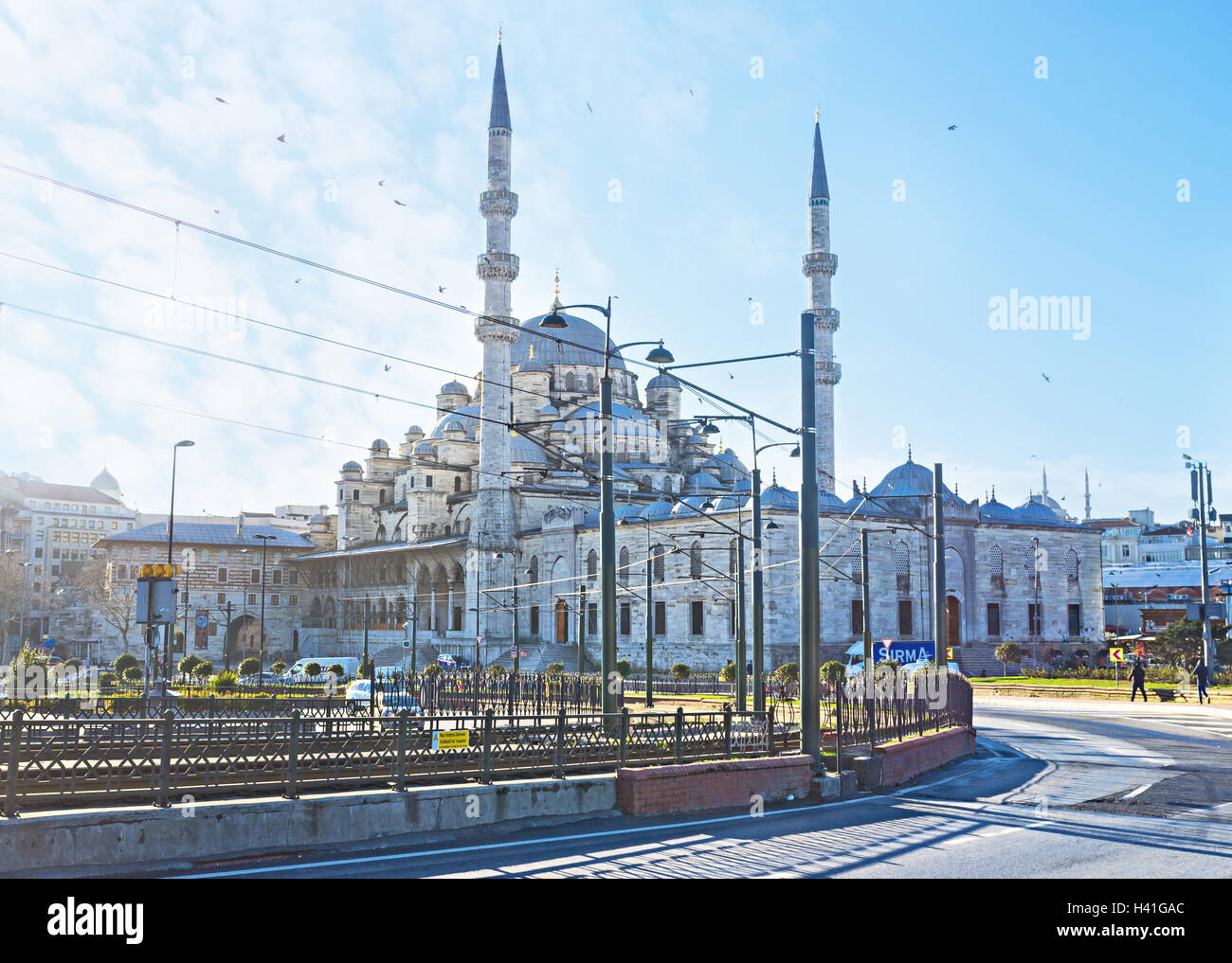 The Yeni Cami Mosque behind the tram line on Galata Bridge, Istanbul, Turkey. Stock Photo