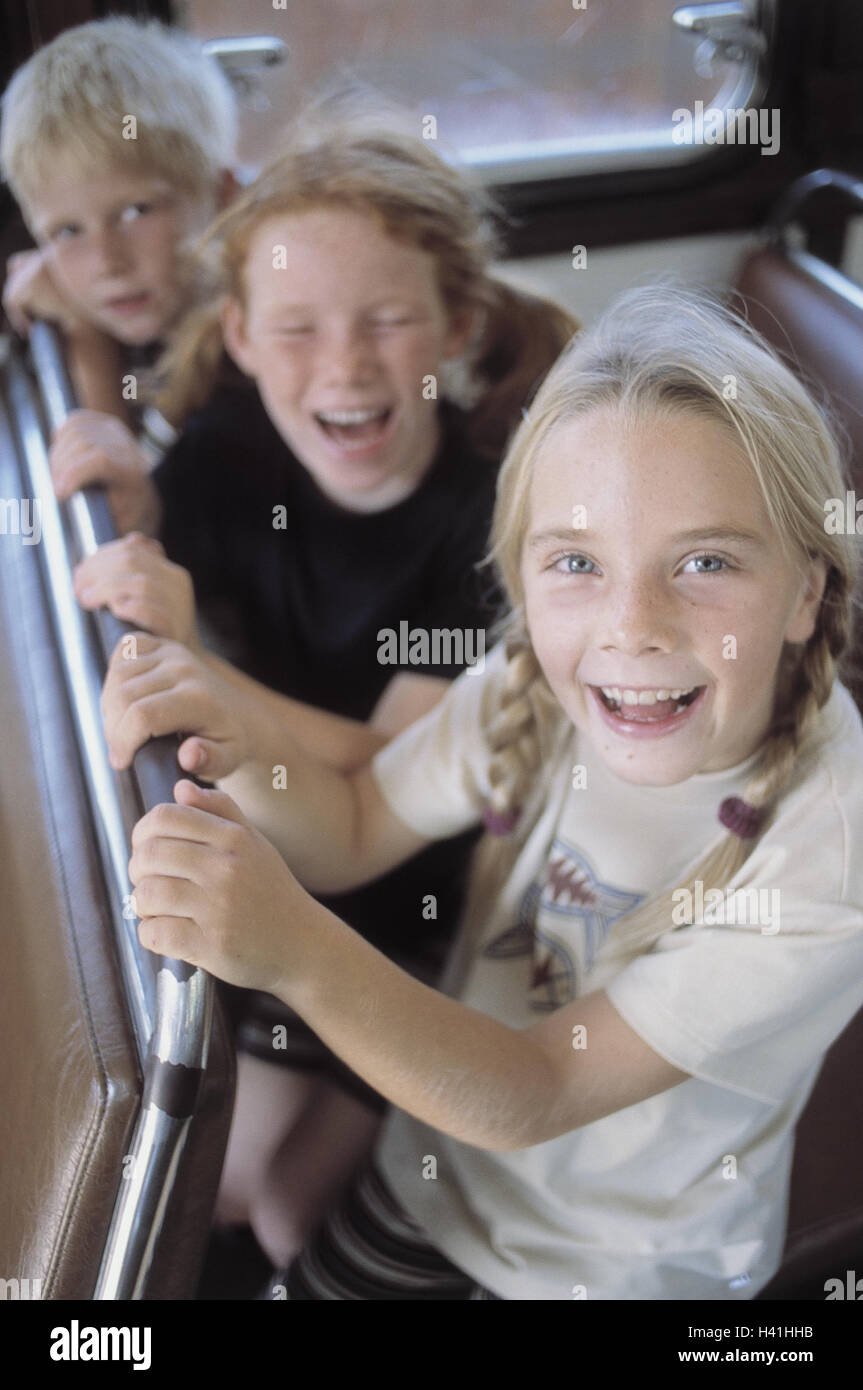 Train compartment, girl, boy, happy, sit, detail, inside, summers, vacation, holidays, leisure time, childhood, children, 7-9 years, fun, excursion, travel, train travel, train journey, trajectory, railway car, carriage, laugh, amuse funnily, joy, happy, Stock Photo