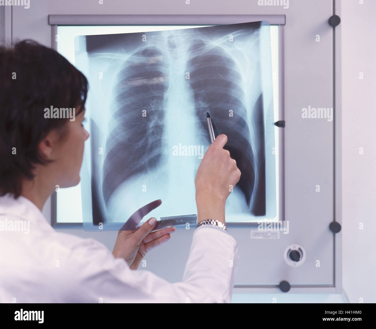 Doctor, luminous notice board, roentgenogram, diagnostic, side view, woman, 30 years, X-ray picture, specialist, doctor, medicine, findings, declare, explain, consult, indicate, precaution, controls, health, disease, occupation, remedial occupation, public health, curled Stock Photo