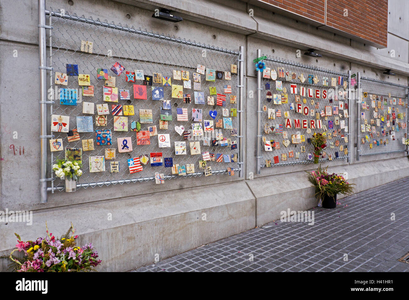 TILES FOR AMERICA. A display of small tiles in a fence commemorating the losses of 9/11. On 7th Ave in the West Village, NYC. Stock Photo