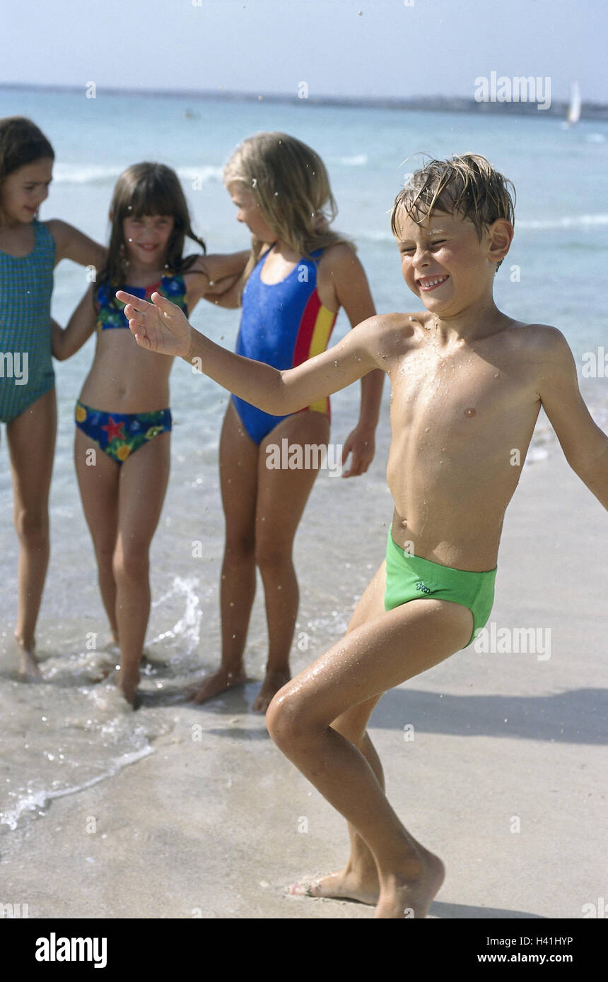 Beach, children, swimwear, happy, very close, outside, sandy beach, Sand, sea, water, vacation, holidays, leisure time, childhood, friends, friendship, girl, boy, four, 7-9 years, play, happy, fun, amuses, embrace, embrace, friends Stock Photo