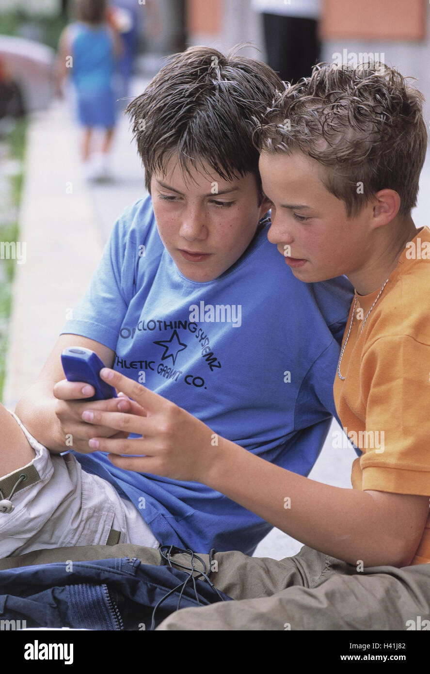 Boys, mobile phone, call up, show SMS summer, outside, children, young persons, teenagers, schoolboys, two, school companion, school friends, friendship, comradeship, mate, friends, leisure time, school end, holidays, entertainment, short communication, m Stock Photo