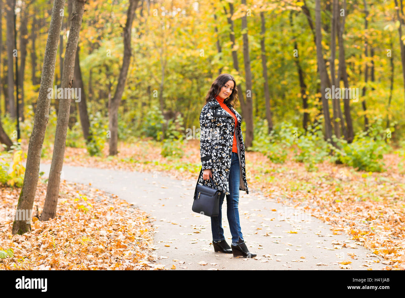 young girl walking in autumn park Stock Photo - Alamy