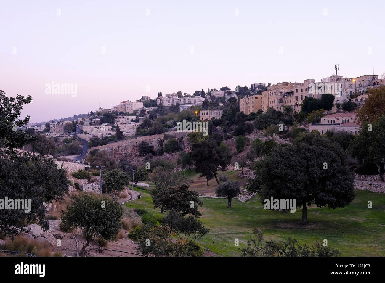 View at twilight of Abu Tor a mixed Jewish and Arab neighborhood located over valley of Hinnom the modern name for the biblical Gehenna or Gehinnom valley surrounding Jerusalem's Old City, Israel Stock Photo