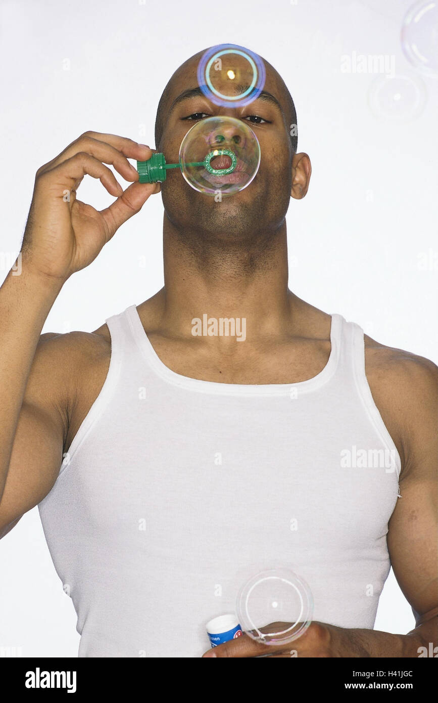 Man, dark-skinned, soap bubbles, half portrait, model released, amusement, fun, humor, funnily, cheerfully, cheerfulness, sportily, athletic, body type, play, childishly, very close Stock Photo