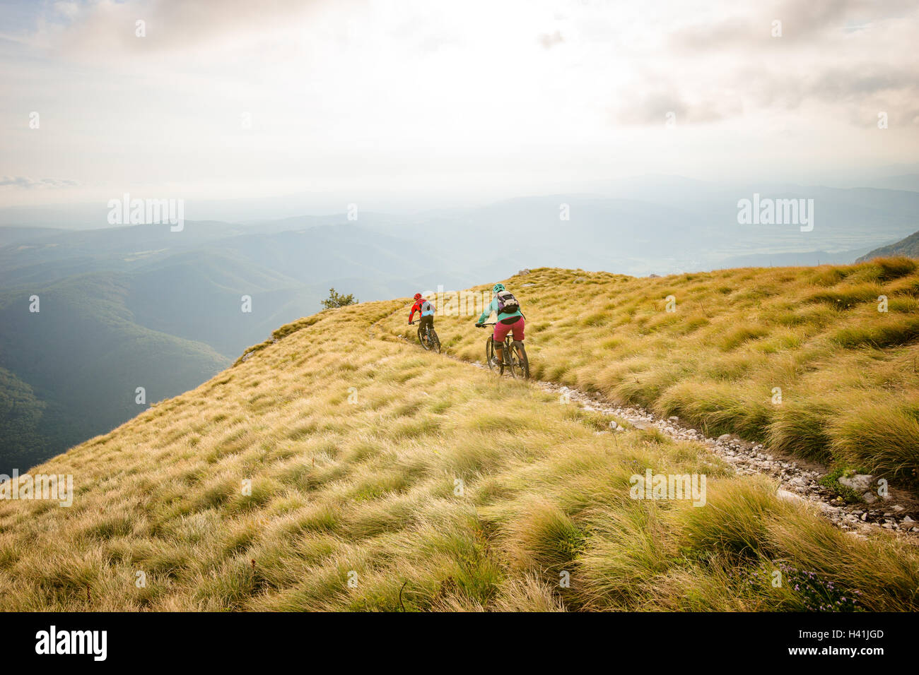 Two people mountain biking on a trail near Vipava, Slovenia Stock Photo