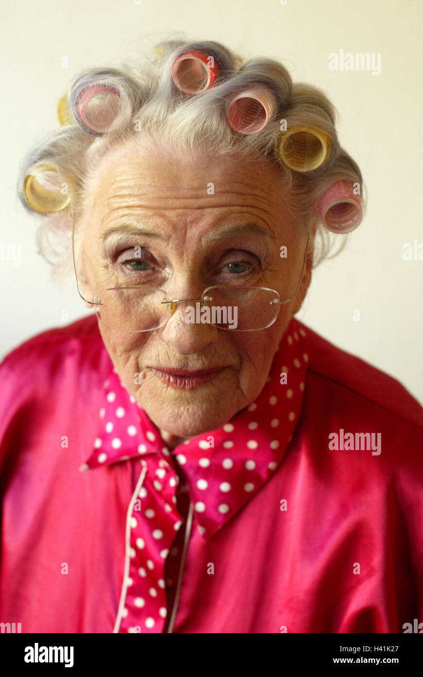 Senior, curler, seriously, view camera, portrait, 60-70 years, woman,  pensioner, old person, old, grey-haired, white haired, blouse red, hairstyle,  hairs, screwed, excitedly, hair care, cosmetics, vanity, beauty, Beauty,  facial play, doubtful, scepticism