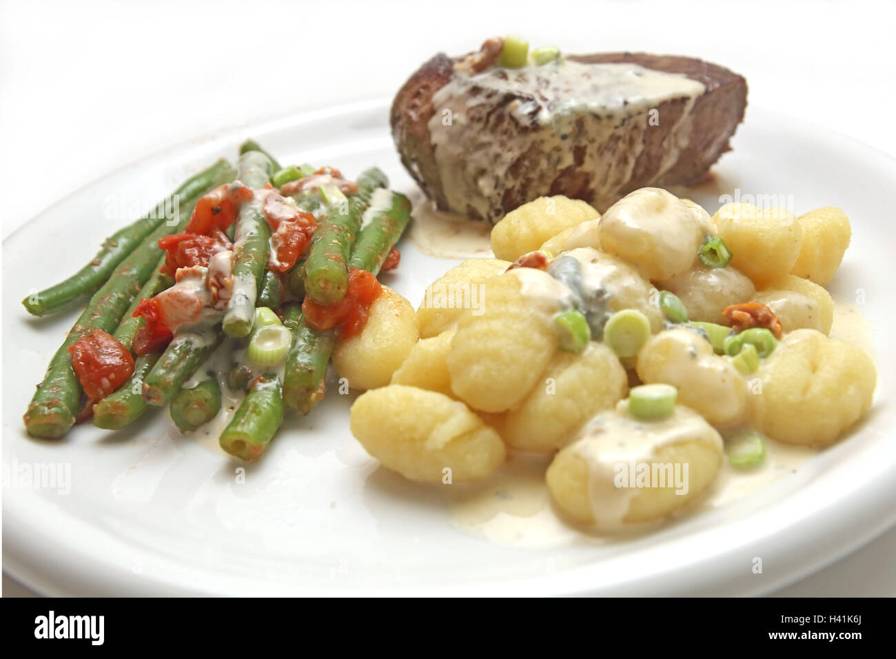 Beef fillet with gnocchi and beans Stock Photo