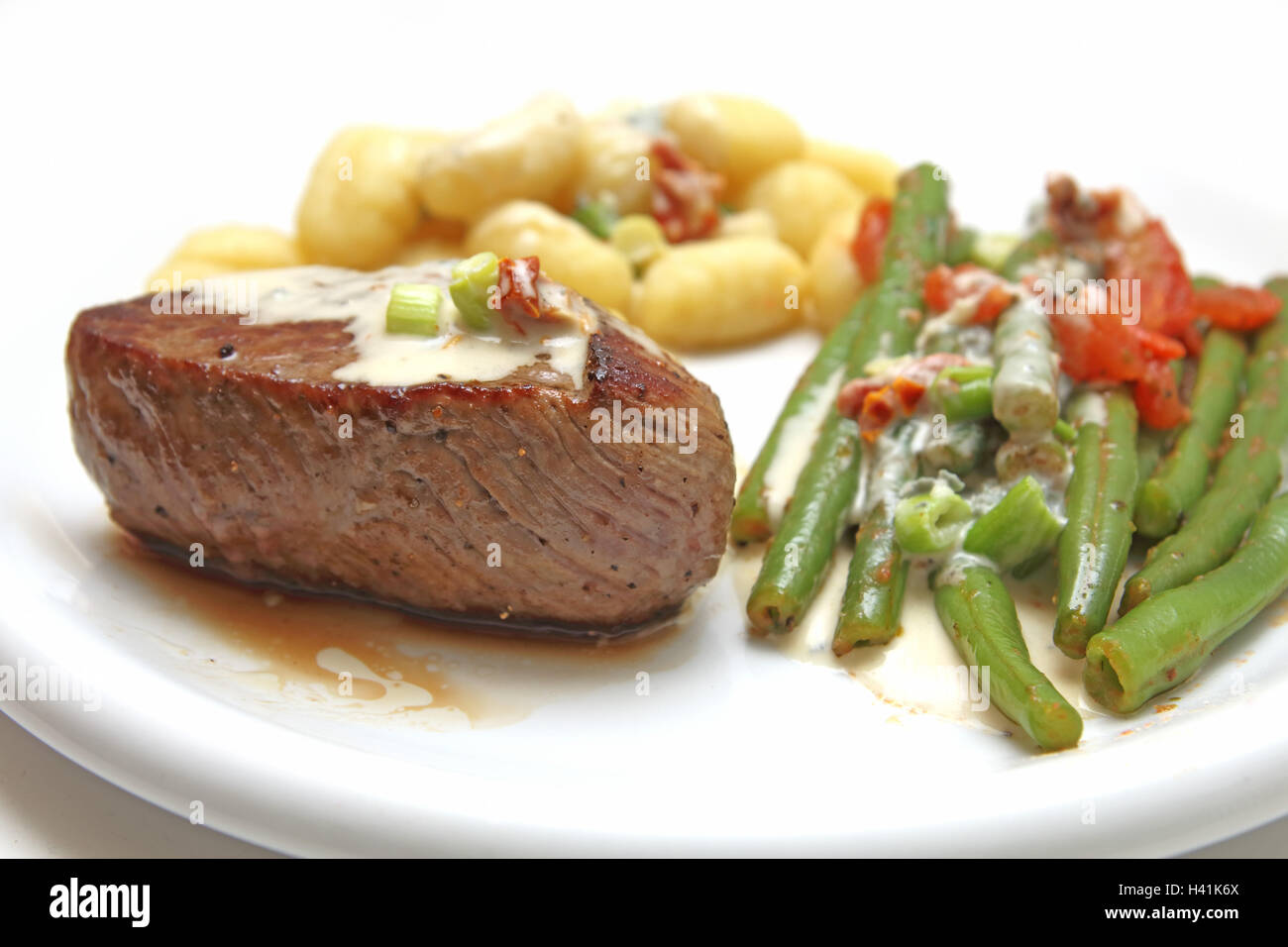 Beef fillet with gnocchi and beans Stock Photo