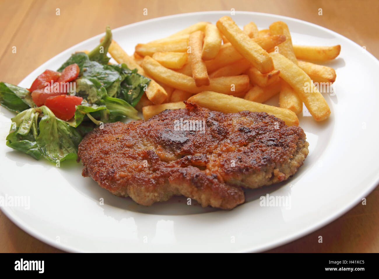 escalope with french fries and corn salad Stock Photo Alamy