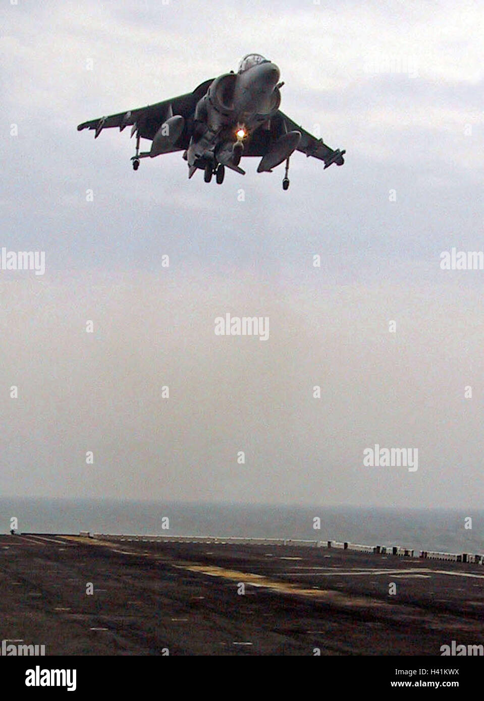 28th January 2003 Operation Enduring Freedom: a U.S. Marines Harrier jump jet hovers above the USS Nassau, in the Persian Gulf. Stock Photo