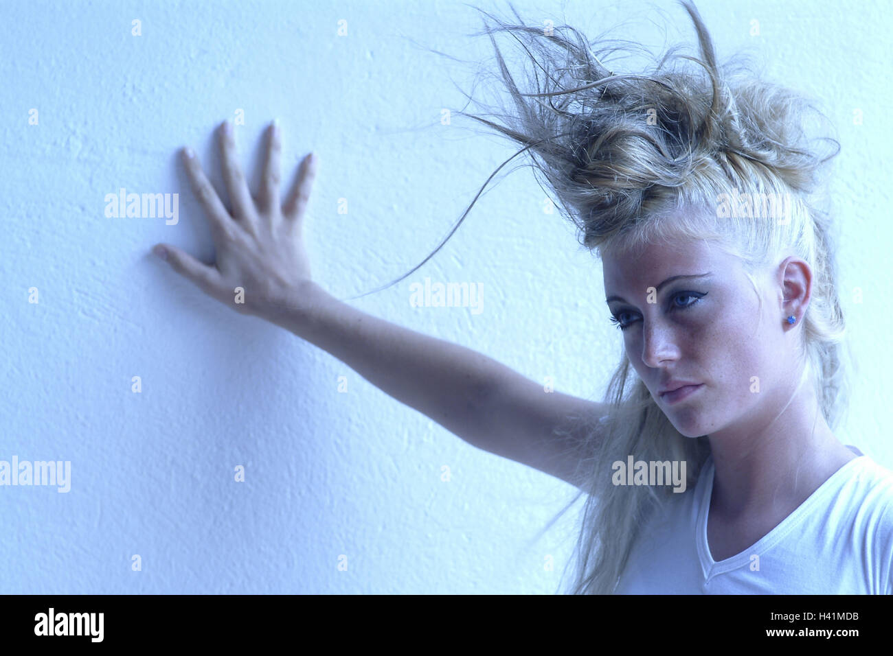 Woman, young, seriously, flighty, gesture, wall, portrait, young persons, 21 years, women's portrait, provocation, style, view, arrogantly, haughtily, provoking, greasepaint, made up, make-up, conspicuously, brightly, hairs, pinned up, hairstyle, punkig, trashy, fashion, fashionably, spectral filter blue, 20-30 years Stock Photo
