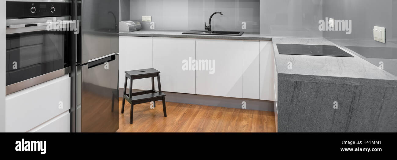 Panorama Of Modern Spacious Kitchen With White Furniture Wooden