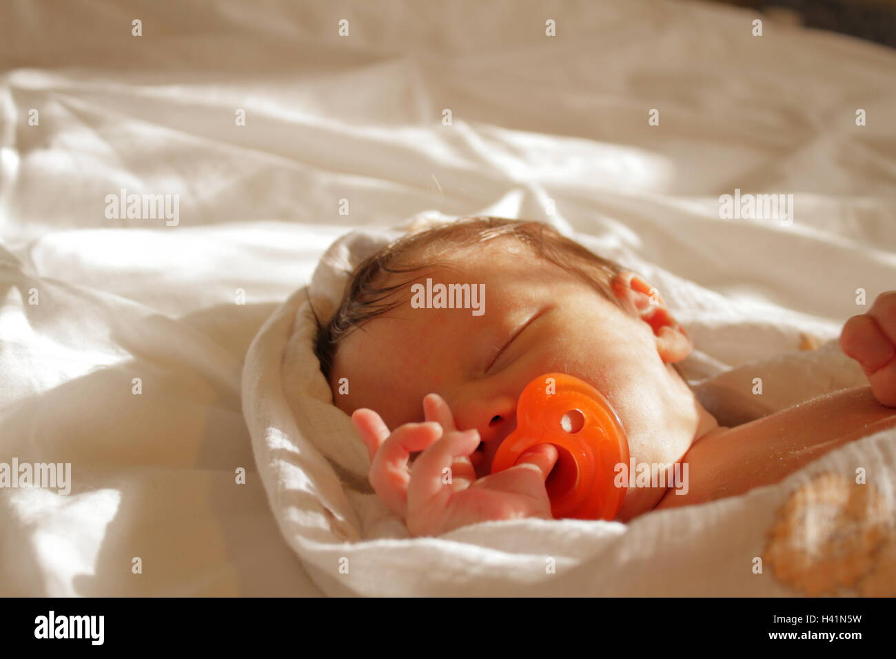 Newborn baby boy sleeping in bed with pacifier Stock Photo Alamy
