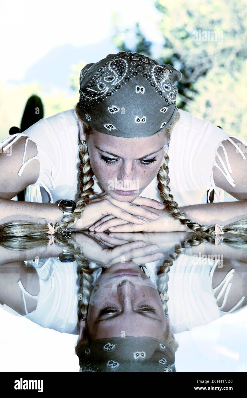 Woman, young, blond, braids, kerchief,  Glass table, resting, serious,  knocked down, reflection 24 years, 20-30 years, emotion, sorrowfully, secluded, depressed, problem, sorrow, worries, longing, lovesickness, table, glass plate, Reflektion Stock Photo