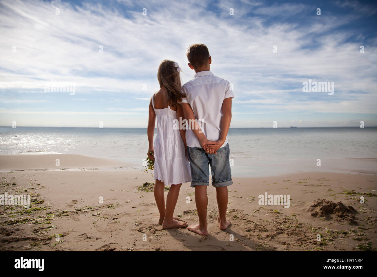 Boy And Girl Standing On The Beach Holding Hands Stock Photo Alamy